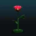 Dekoracja świetlna LED w kształcie róży na ciemnym tle, nowoczesny fotopunkt z podświetlanym kwiatem i zieloną łodygą, przeznaczony do przestrzeni miejskich, parków i instalacji plenerowych.