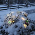 Lampki LED Multikolor 160.diod na zaśnieżonym krzewie – odporne na mróz oświetlenie świąteczne do ogrodu, długość 16 m.