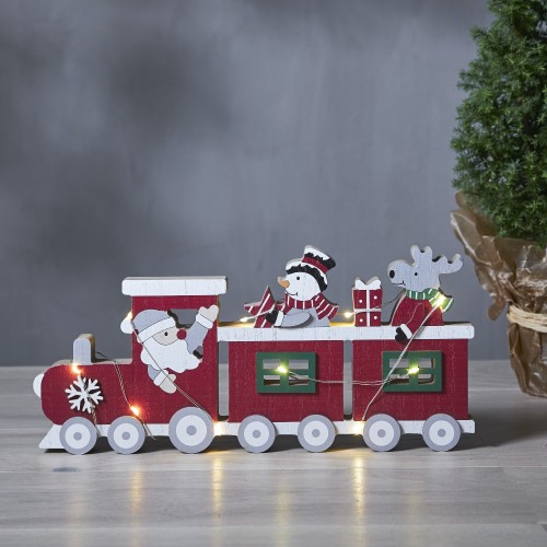 Drewniany czerwony pociąg świąteczny LED z Mikołajem w lokomotywie oraz bałwankiem i reniferem w wagonach, stojący na jasnym blacie jako nastrojowa bożonarodzeniowa dekoracja do domu.