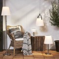 Solarne ogrodowe lampy LED z białymi kloszami w różnych wariantach, stołowa, podłogowa i wisząca, ustawione w aranżacji tarasu w otoczeniu roślin i naturalnych dodatków.