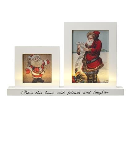 Zdjęcie ramki LED FUGA z dwoma podświetlanymi obrazkami świątecznymi z Mikołajem, napis na podstawie: Bless this house with friends and laughter.