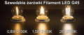 Porównanie trzech żarówek LED G45 marki STAR Trading o barwie 2100K i różnych mocach: 0,5W, 0,8W i 1,5W. Żarówki ustawione na ciemnym tle, emitują światło o różnej intensywności.