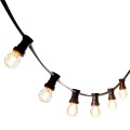 Girlanda ogrodowa z czarnym przewodem i sześcioma żarówkami LED G45 4W 2100K z 3-stopniowym ściemnianiem. Żarówki w przezroczystych bańkach emitują ciepłe światło. Zdjęcie na białym tle.