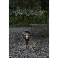 Lampa ogrodowa ORBY z kulistym dymionym kloszem i czarną podstawą do ustawienia lub wbicia w podłoże.
