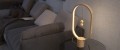 Lampa stołowa LED z podłużnym źródłem światła umieszczonym wewnątrz dekoracyjnej owalnej ramy.