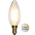Dekoracyjna żarówka LED filament w kształcie świeczki z małym gwintem E14 i funkcją 3-Step Memory. Przezroczysta bańka z czterema filamentami LED emitującymi ciepłe światło do lamp świecznikowych i dekoracyjnych.