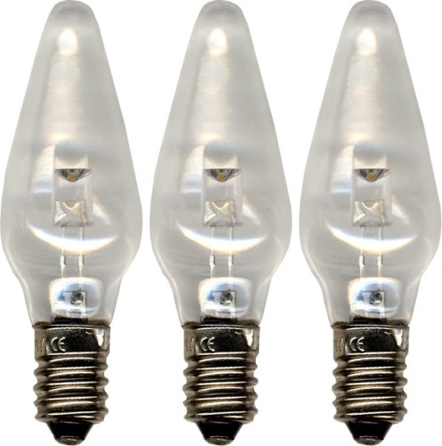 Trzy małe żarówki LED w kształcie płomienia ustawione obok siebie. Przez przezroczyste szkło widoczny jest pojedynczy element LED oraz metalowe gwinty E10. Tło białe.