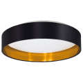 Okrągła lampa sufitowa LED MASERLO 2 20W w czarnym kolorze, ze złotym wnętrzem i białym panelem świetlnym od spodu.