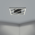 Na suficie lampa LED ULISANO tworzy geometryczny układ przecinających się jasnych linii, które kontrastują z czarną konstrukcją oprawy.