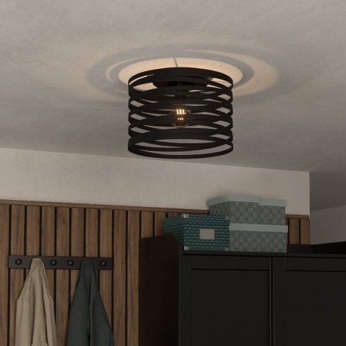 Czarna lampa sufitowa CREMELLA z ażurowym metalowym kloszem, zamontowana na suficie i emitująca światło przez poziome szczeliny.