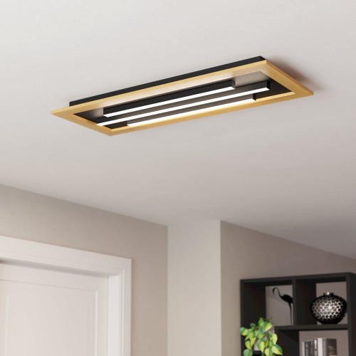 Lampa sufitowa LED TIRRENARA z podłużną czarno-złotą konstrukcją, zamontowana na suficie i emitująca białe światło.
