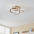 Lampa sufitowa LED ROLIMARE 35W z trzema przeplatającymi się pierścieniami, zamontowana na suficie w jasnym nowoczesnym wnętrzu.