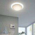 Okrągła lampa sufitowa LED MARGITTA 1 11W zamontowana w jasnym wnętrzu, emitująca ciepłe białe światło 3000K.