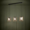 Lampa wisząca CAMINATA z trzema szklanymi kloszami o transparentnym wykończeniu, zawieszona na czarnych przewodach i emitująca ciepłe światło.