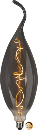 Dekoracyjna żarówka LED filament w kształcie płomienia z przydymioną szklaną bańką i spiralnym filamentem LED emitującym ciepłe światło. Designerska żarówka E27 kompatybilna ze ściemniaczem do lamp dekoracyjnych.