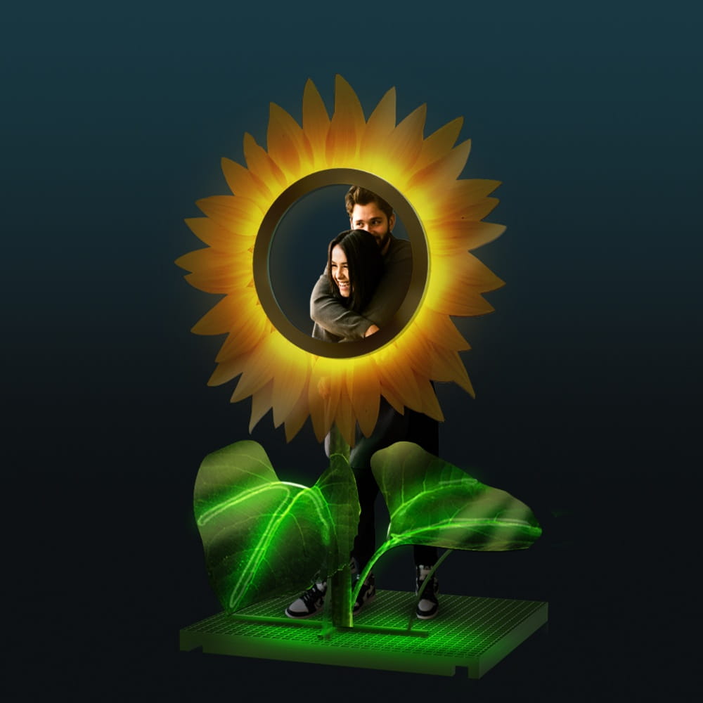 Dekoracja świetlna LED w kształcie słonecznika na ciemnym tle, nowoczesny fotopunkt z podświetlanymi płatkami i zielonymi liśćmi, przeznaczony do przestrzeni miejskich, eventów i instalacji plenerowych.