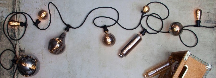 Dekoracyjna girlanda z żarówkami LED G80 w stylu vintage, dymione szkło i ciepła barwa światła, aranżacja w przestrzeni dekoracyjnej.