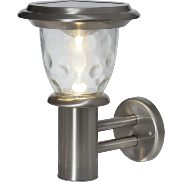 Kinkiet solarny z dekoracyjnym, transparentnym kloszem, który efektownie rozprasza światło LED. Prosta forma i kompaktowy rozmiar sprawiają, że doskonale pasuje do oświetlenia elewacji lub wejścia.